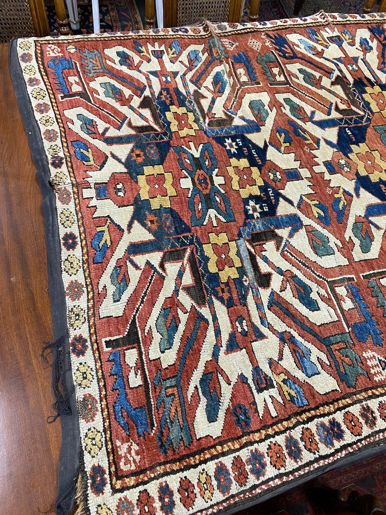 An antique Caucasian ivory ground Karabagh triple medallion rug, 224 x 130cm